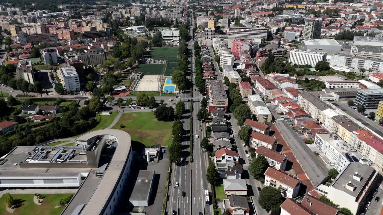 Aerial view of Braga's main avenue with cars moving through a vibrant urban area