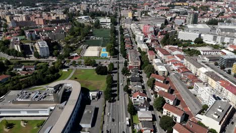 aerial view of braga's main avenue with cars moving through a vibrant urban area