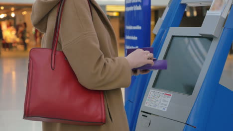 mujer haciendo el auto-check-in en el aeropuerto