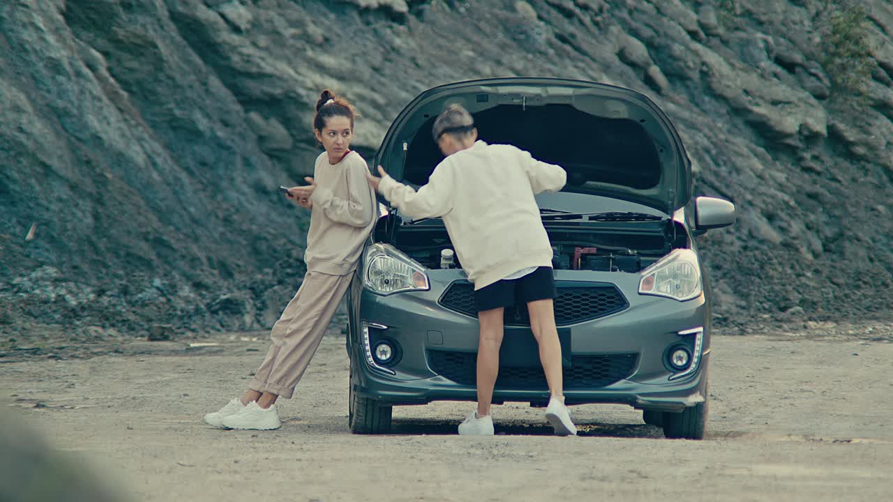 Couple dealing with a car breakdown on the road