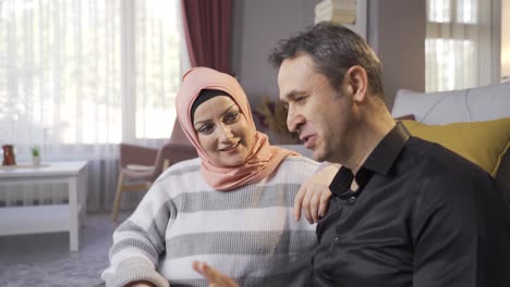 Happy-Muslim-family.-Husband-and-wife-chatting-at-home.