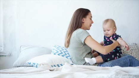 Mother and Baby Playing on Bed
