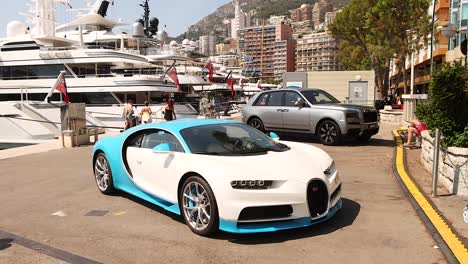 a bugatti supercar driving near yachts