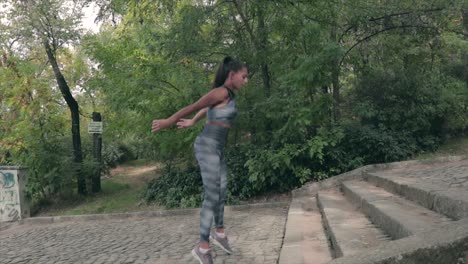 Girl-exercising-on-the-stairs-of-a-park