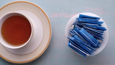 cup of tea with sugar packets