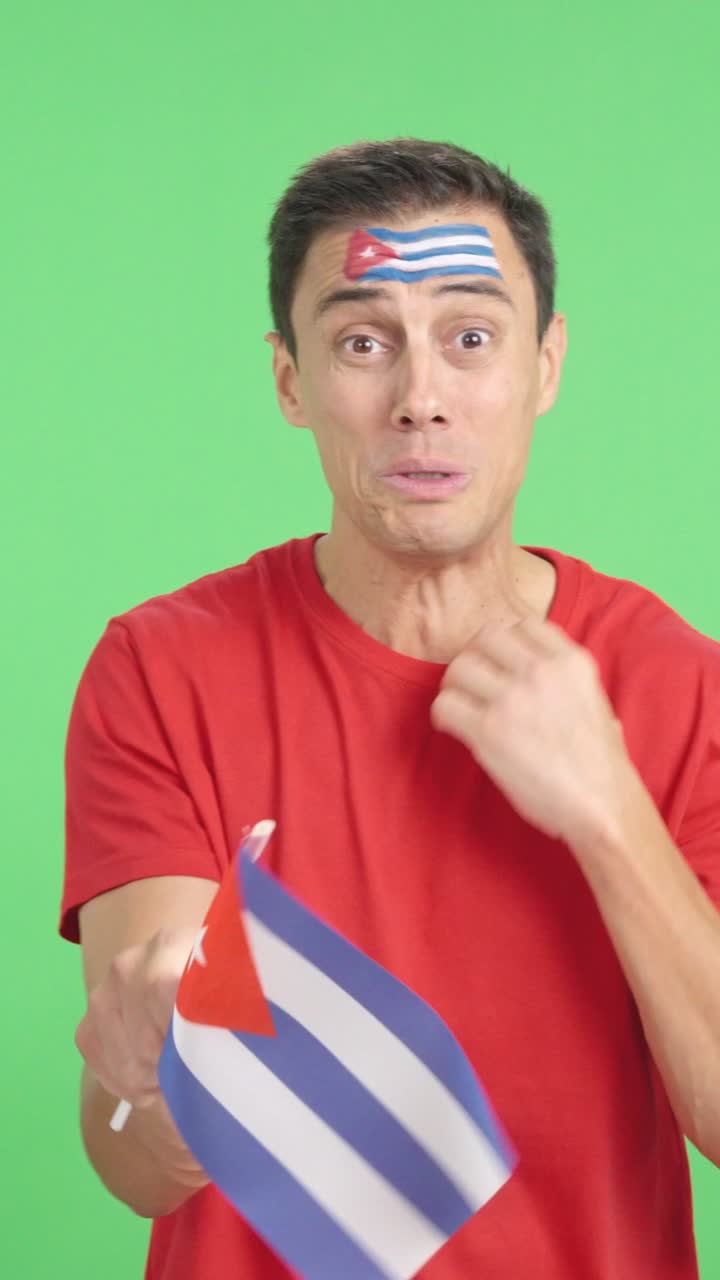 Man cheering for Cuba during a match that is lost