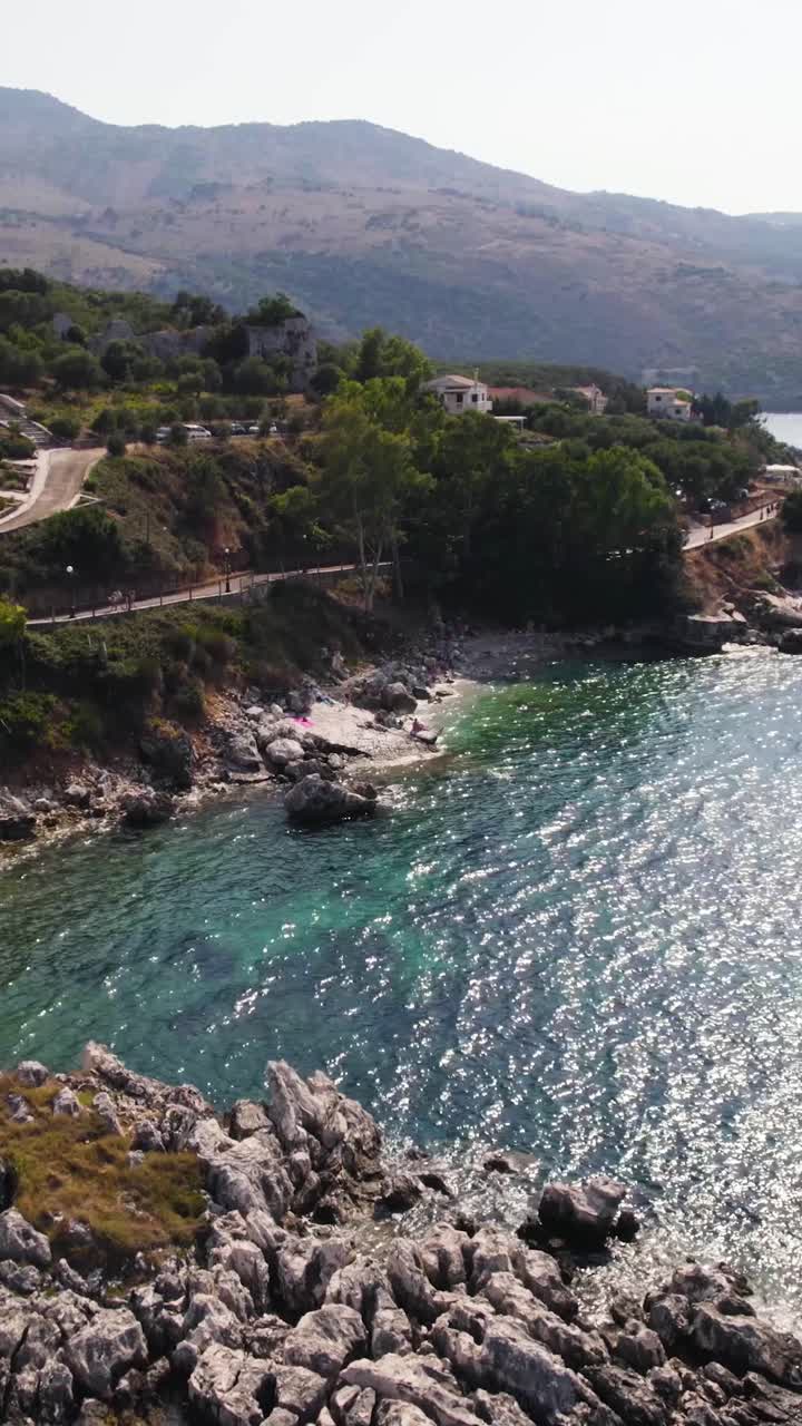 Smooth aerial flyover of Kassiopi’s lesser-known beaches and reefs, highlighting turquoise waters and tranquil Ionian coastal landscapes