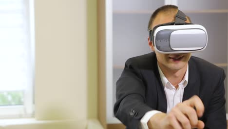 business man using vr glasses. good looking business manager relaxing at a room and using vr glasses