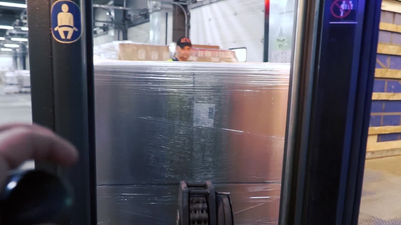 Forklift Loading a Large Package in a Truck