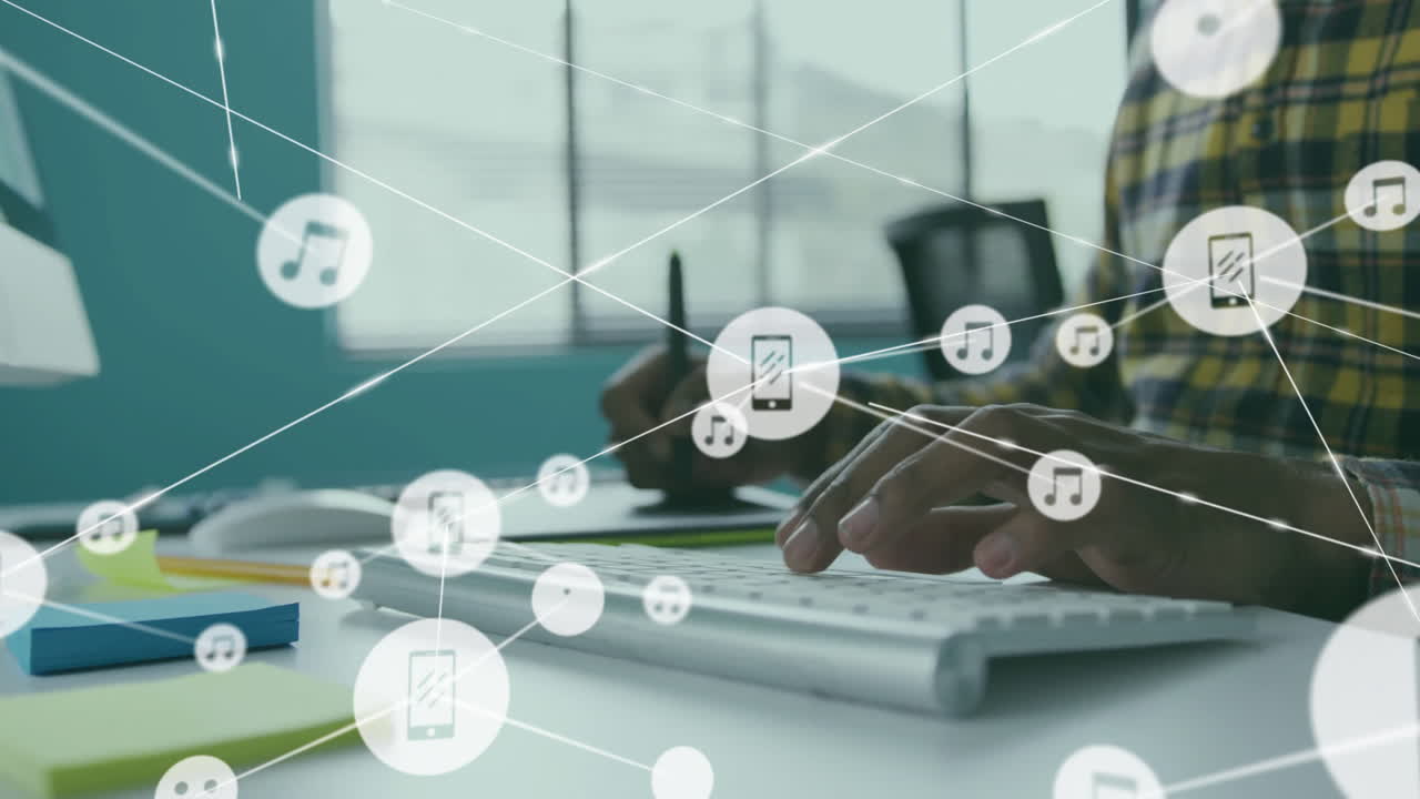 Animation of connected icons over midsection of african american man using graphics tablet