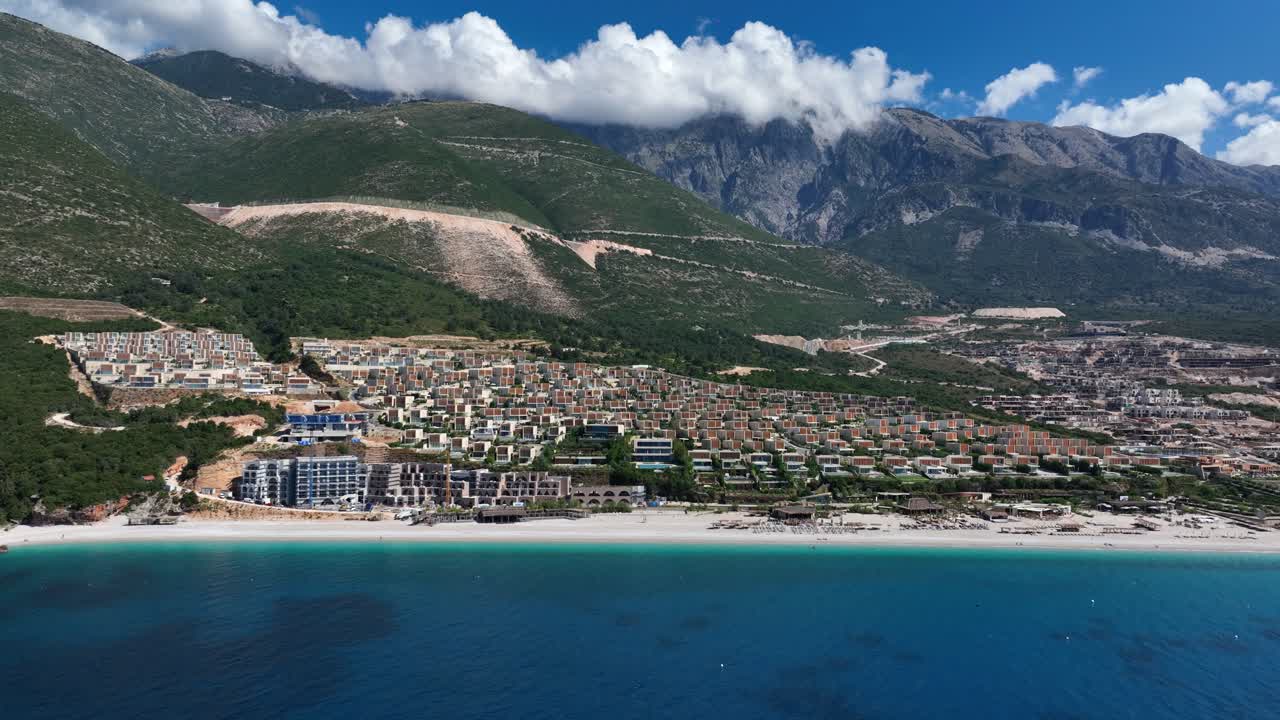 Coastal resort in Palasë, Albania with green hills and turquoise beach view
