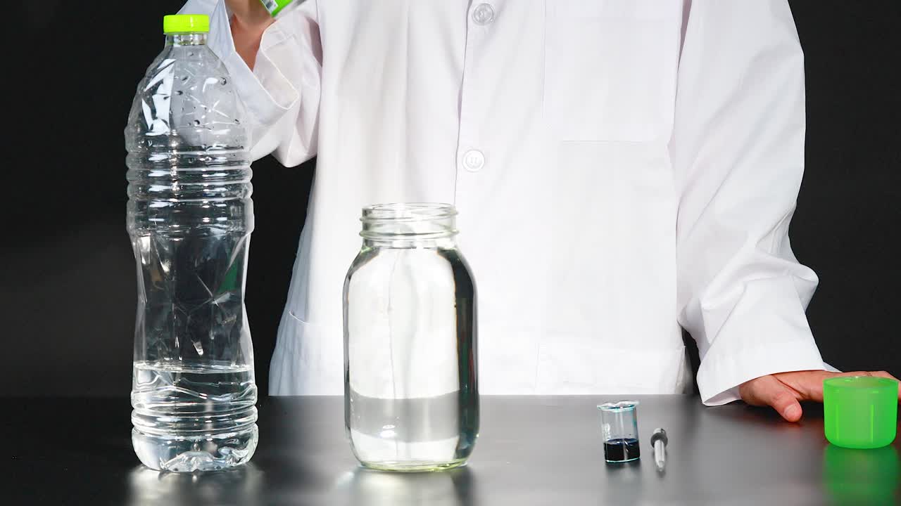 A person in a lab coat performs a chemical reaction using shaving cream and liquids in a laboratory setting