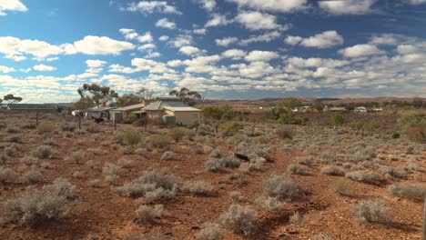 experience the timeless beauty of beltana, a historic outback town nestled in south australia's rugged flinders ranges. this shot showcases the dry, sun-drenched landscape under a vast blue sky.