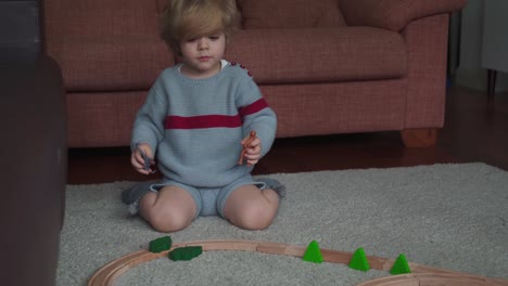 little boy playing with dinosaurs