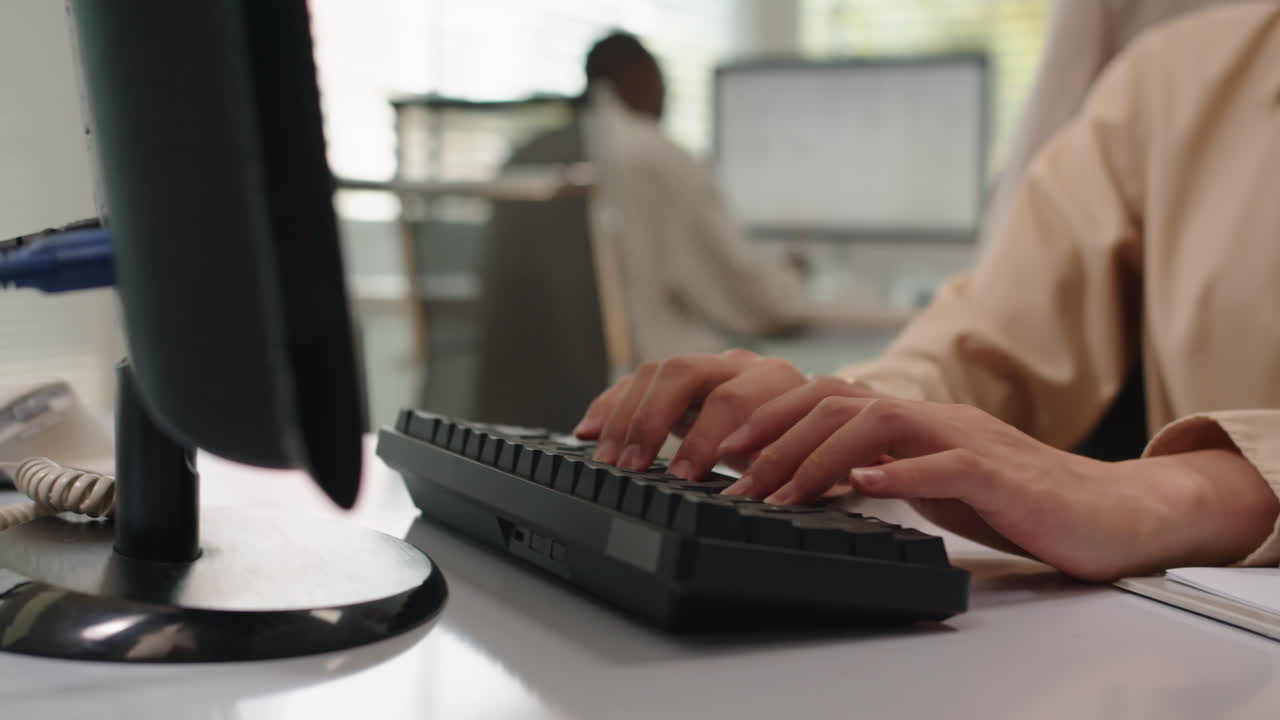 Serious Female Manager Filling Information on Computer