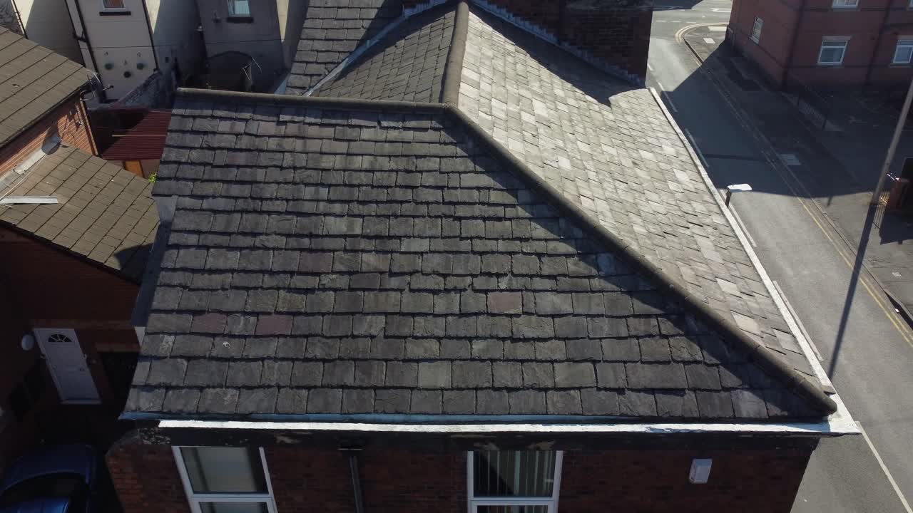 Rooftop inspection aerial view inspecting damage and repair of property for homeowner