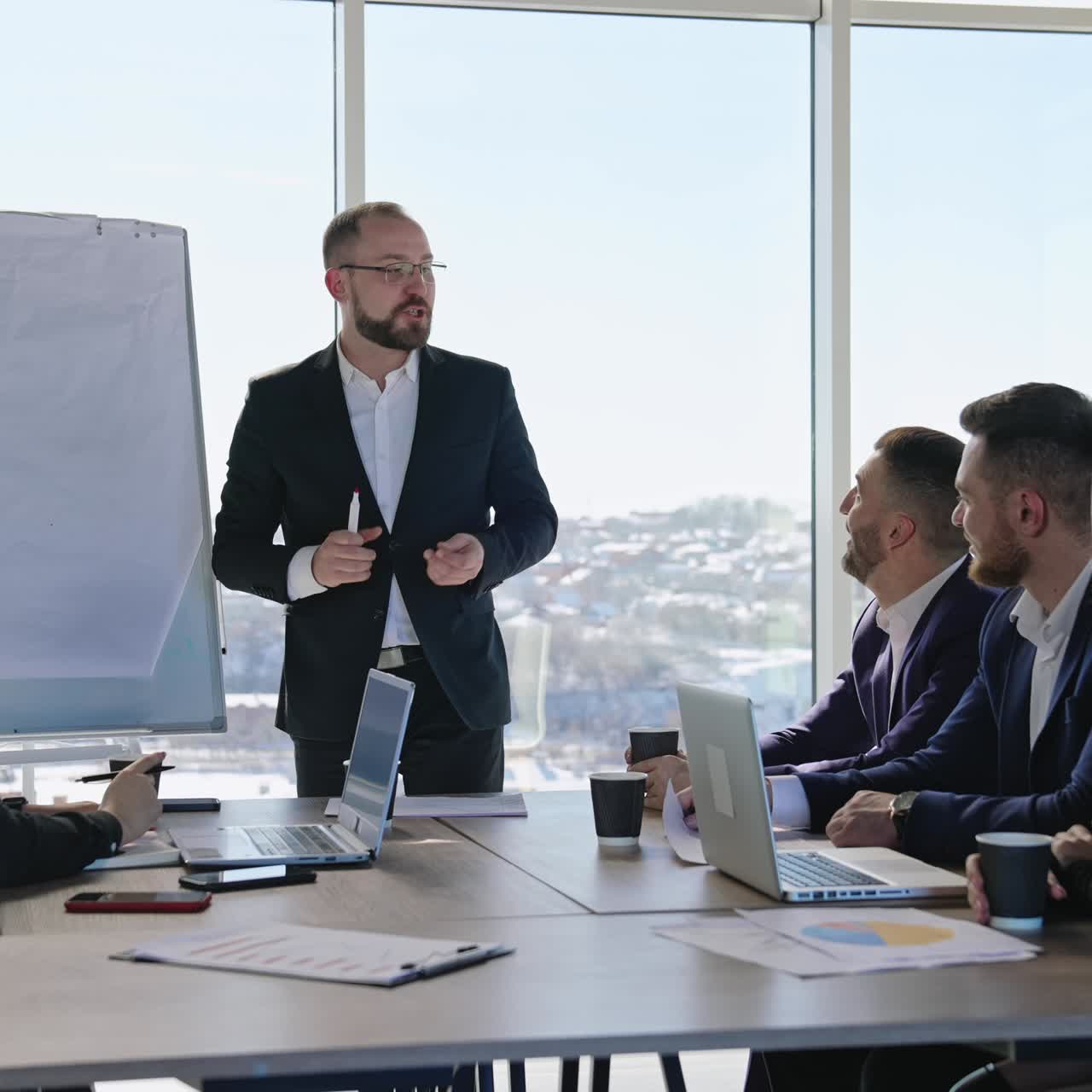 Speaker is having presentation of ideas with the help of a chart. Middle-aged confident employee promoting new ideas