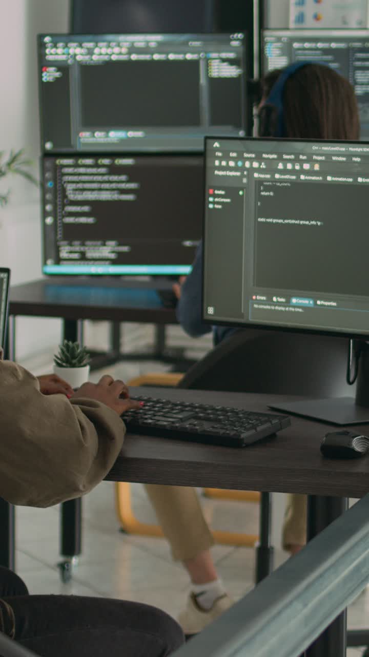 Vertical video: App software developer typing machine learning app code on computer