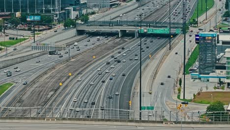 aerial wide shot of traffic scene in american highway during sunny day. busy rush hour in metropolis with multi line intersection.