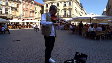 street musician playing violin in a european square