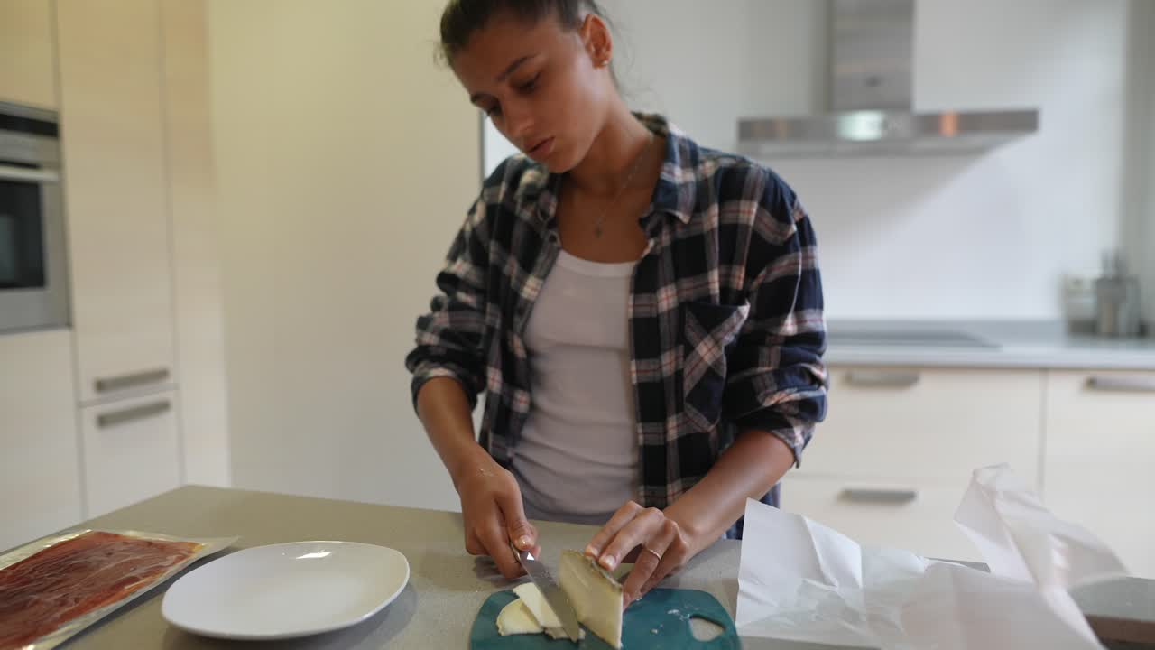 Woman Cutting Cheese in Kitchen