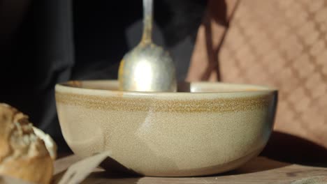 person eating soup with bread