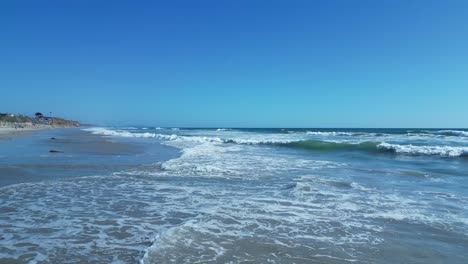 drone flight over ocean waves on a beautiful sunny day in carlsbad california