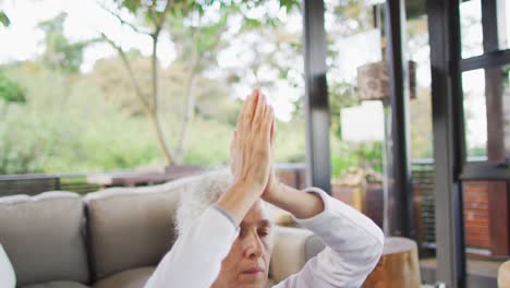 Senior-mixed-race-woman-practicing-yoga,-meditating