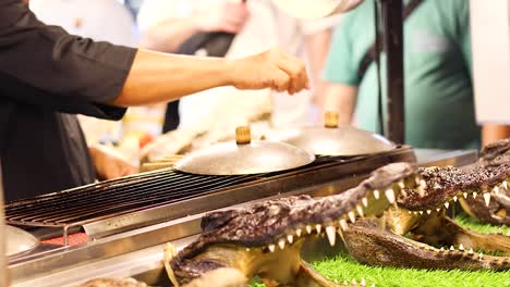 grilling crocodile meat at ao nang market