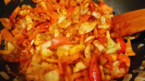 frying yellow and red paprika slices