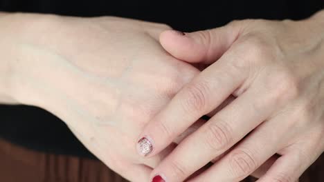 close-up of hands with painted nails