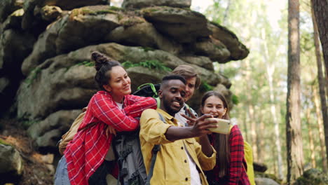 friends taking a selfie in a forest