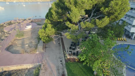 drone lifting to show the sea at the left of the hotel in mallorca spain