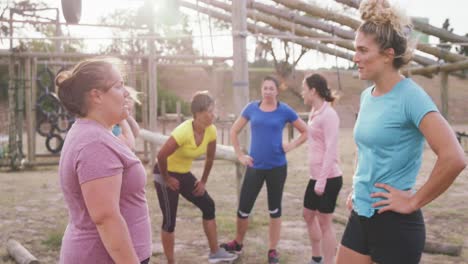 Female-friends-enjoying-exercising-at-boot-camp-together