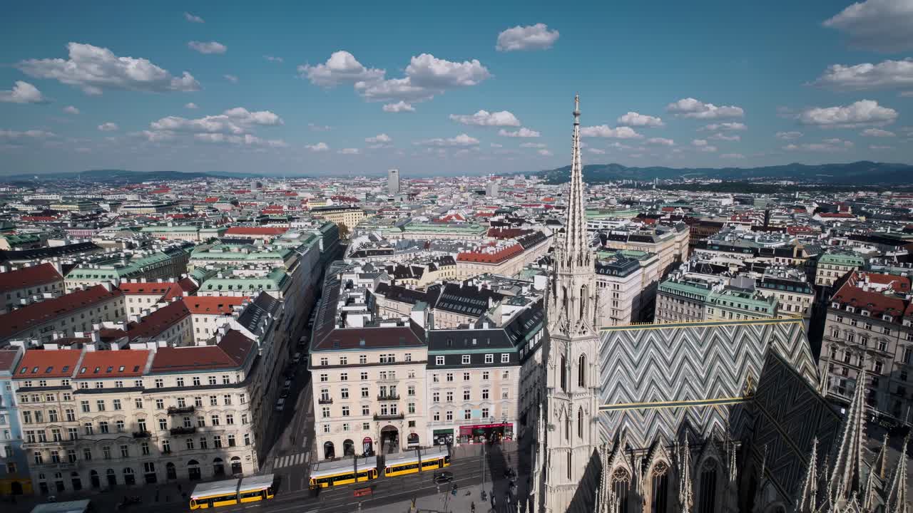 Aerial video view of a historic European cityscape with colorful rooftops and a Gothic cathedral