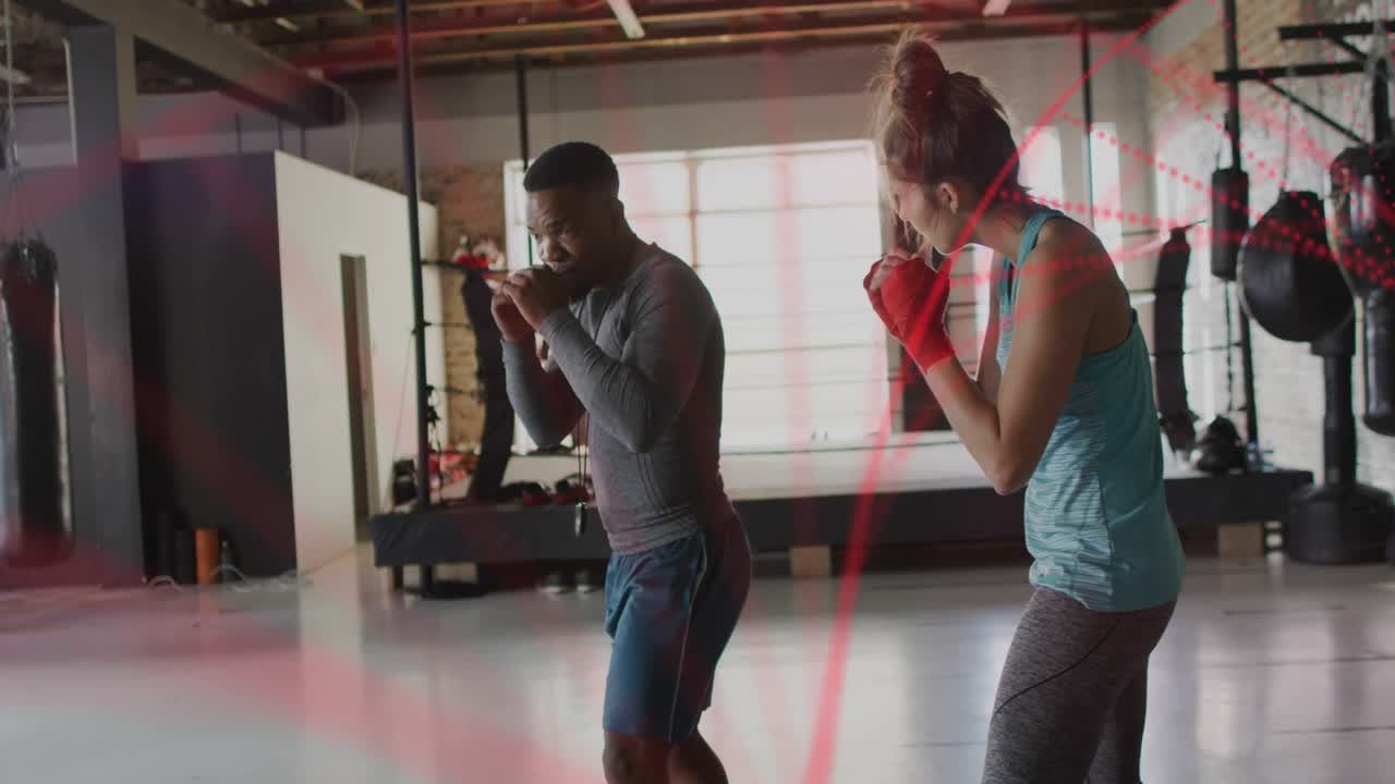 Trainer cueing with timer watching boxer punching jabs and slipping red overlay showing form