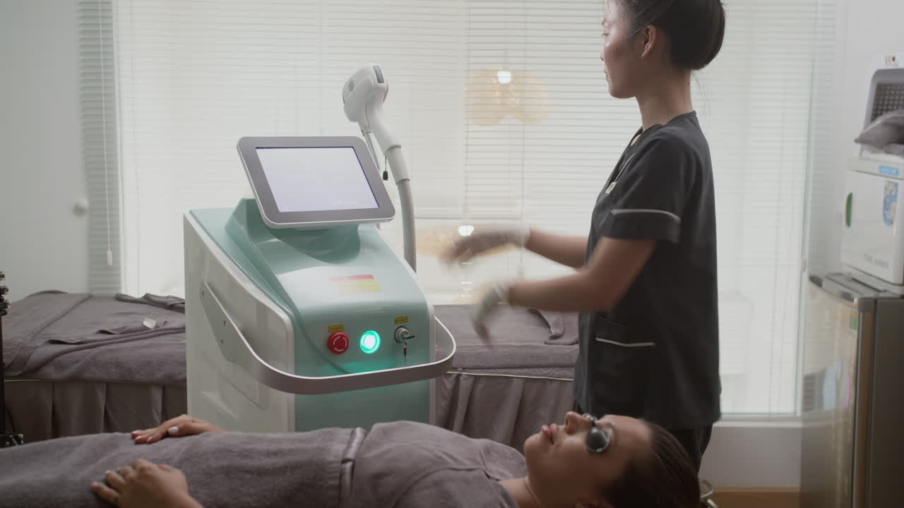 Female Client Getting Laser Rejuvenation Facial Procedure at Salon