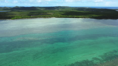 wide aerial flyover looking down on boat pass, northern point of new caledonia