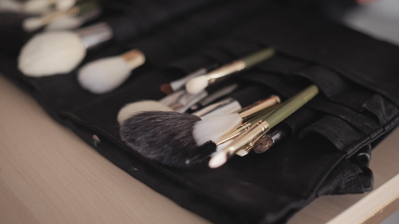 Close-up of makeup brushes on a table for beauty routine setup
