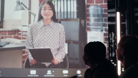 coworkers participate in a late night digital meeting with general director