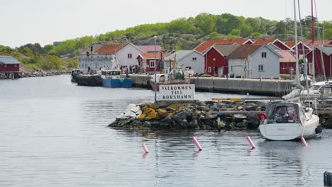welcome to korshamn signage in swedish at the harbor on norwegian border near bohuslan in west sweden. wide shot