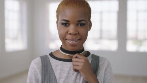 portrait of cool trendy african american woman looking pensive at camera confident successful black female in new apartment