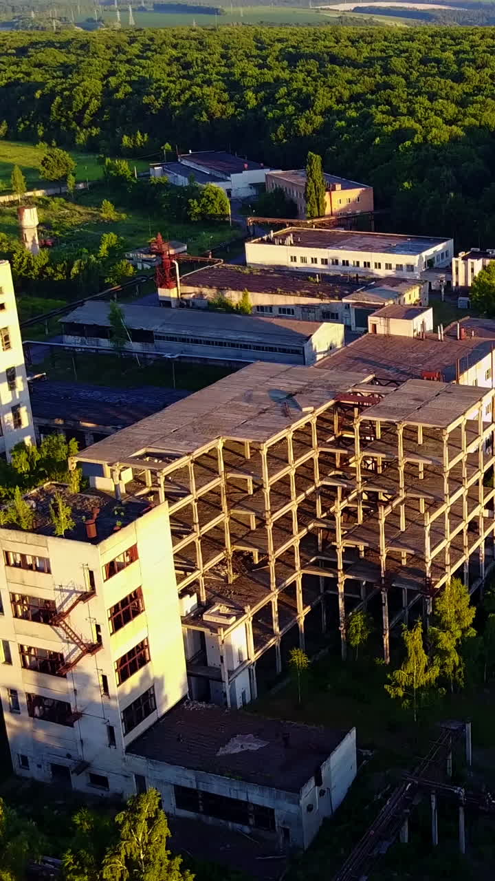 Old Industrial Factory Buildings. Vintage old big factory with closed door and broken windows Vertical video
