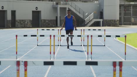 Front-view-of-african-american-athlete-doing-hurdling