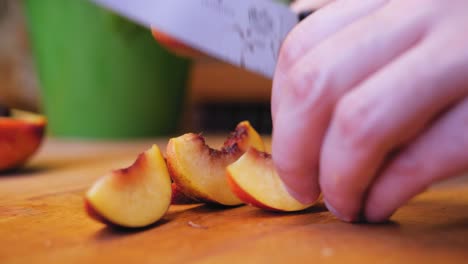 the cook cuts the nectarine on a wooden board