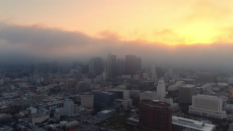 serene aerial view of a foggy los angeles skyline at golden hour