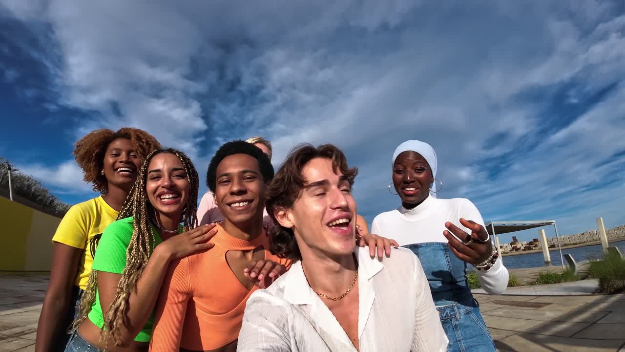 A group of diverse friends taking a selfie and smiling
