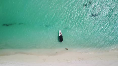 Overhead-shot-of-a-motorboat-anchored-off-a-Caribbean-coast