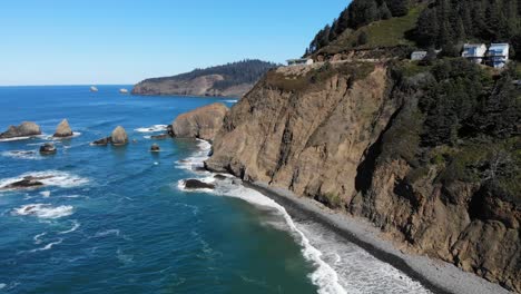 drone flies around a cliff at the ocean