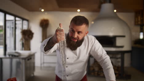 culinary chef baking bread in kitchen. man baker cooking flour recipe in cafe.